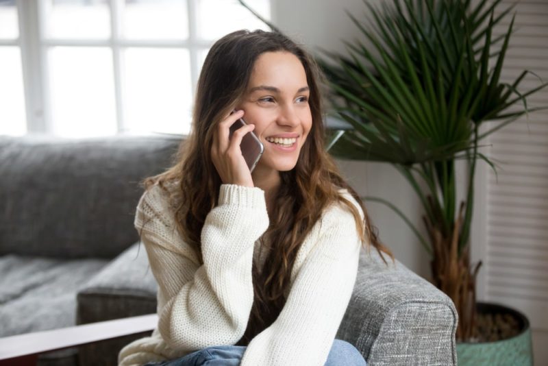 Woman on the phone hiring junk removal services
