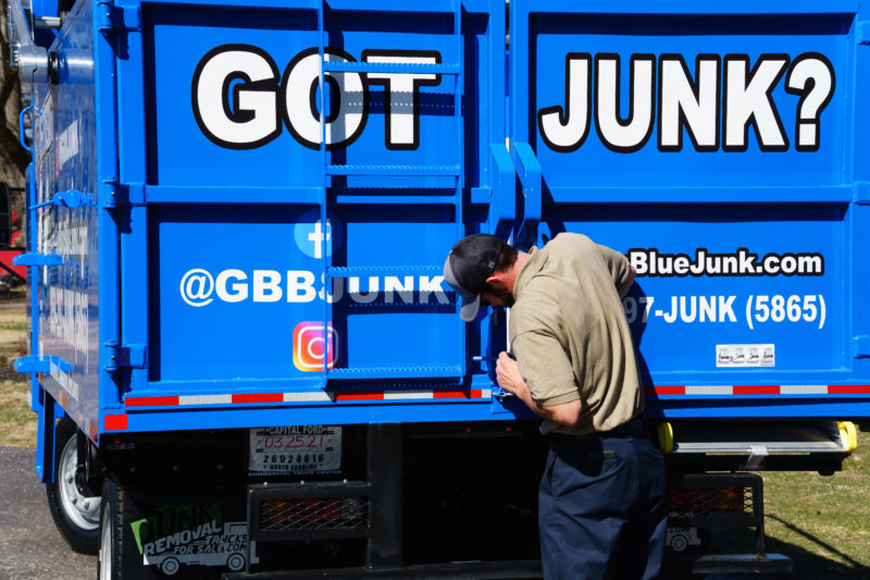 Go Big Blue junk removal expert closing truck doors