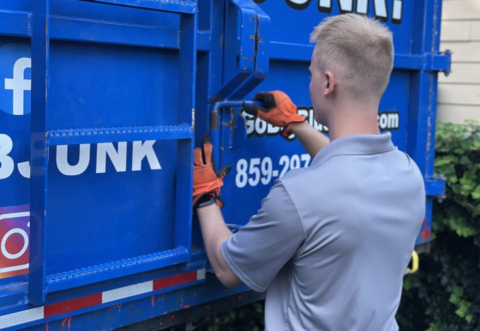go big blue junk removal expert closing junk truck doors